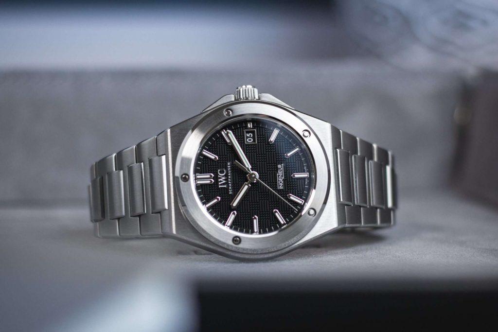 IWC Ingenieur mit schwarzem Zifferblatt liegend abgebildet vor grauem Hintergrund