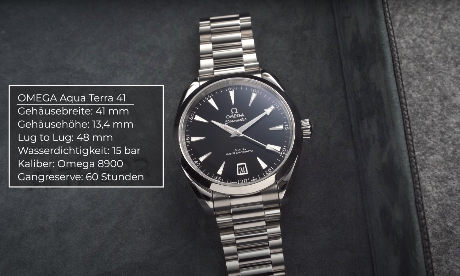 Die OMEGA Seamaster Aqua Terra mit schwarzem Lackzifferblatt am Edelstahlarmband liegend vor dunklem Hintergrund und eine Einblendung der Daten der Uhr