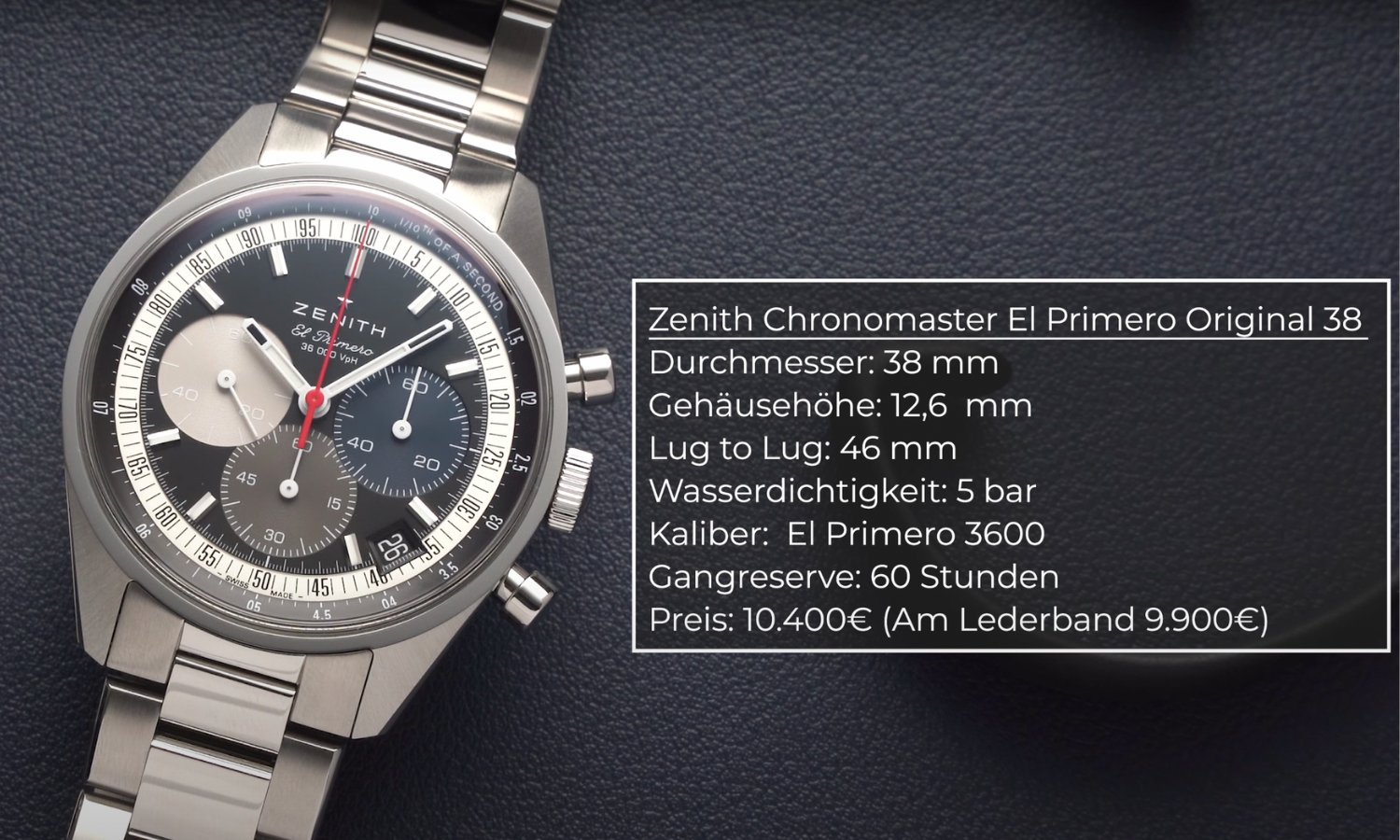 Die Zenith Chronomaster El Primero Original 38 mit schwarzem Zifferblatt am Edelstahlarmband liegend vor dunkelgrauem Hintergrund