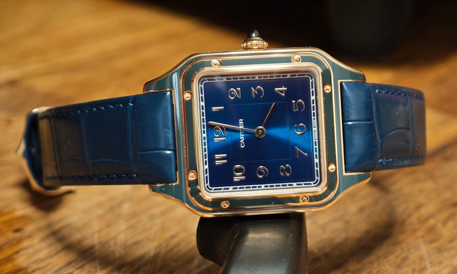 Seitlicher Blick auf die Cartier Santos Dumont mit der Referenz WGSA0098, die an einen Gegenstand gelehnt ist.