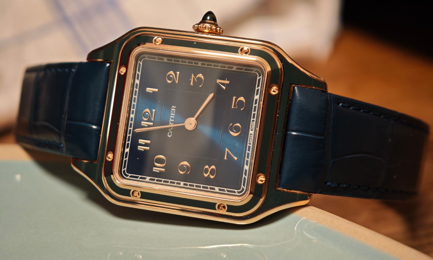 Seitlicher Blick auf die Cartier Santos Dumont mit der Referenz WGSA0098, die an einen Gegenstand gelehnt ist.