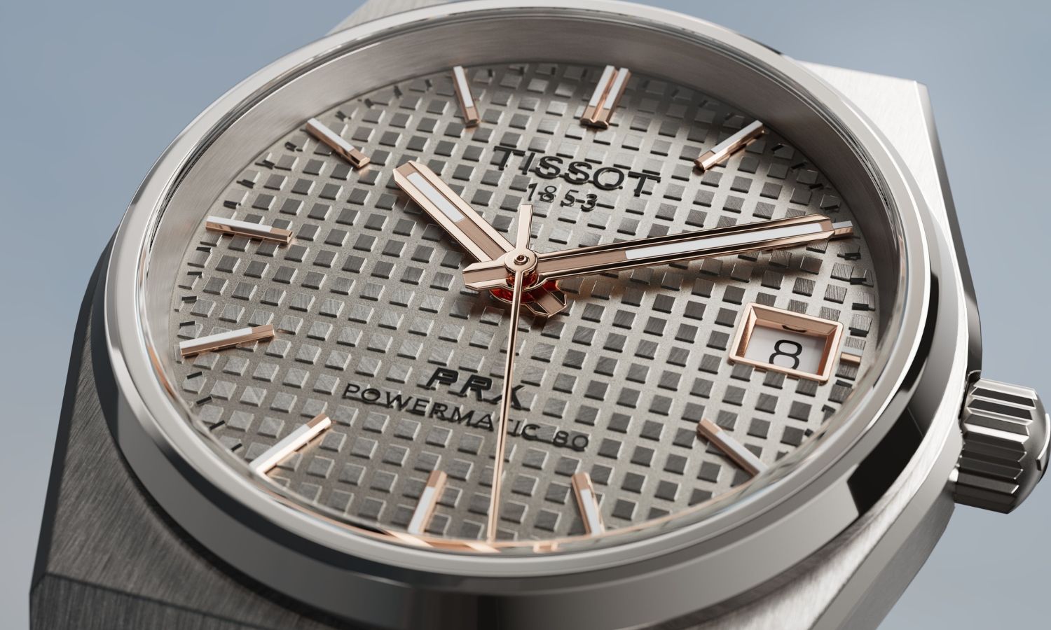 Nahaufnahme des anthrazitfarbenem Zifferblatts der Tissot PRX Powermatic 80 38 mm Titan (Ref. T1378074406100) abgebildet vor hellgrauem Hintergrund